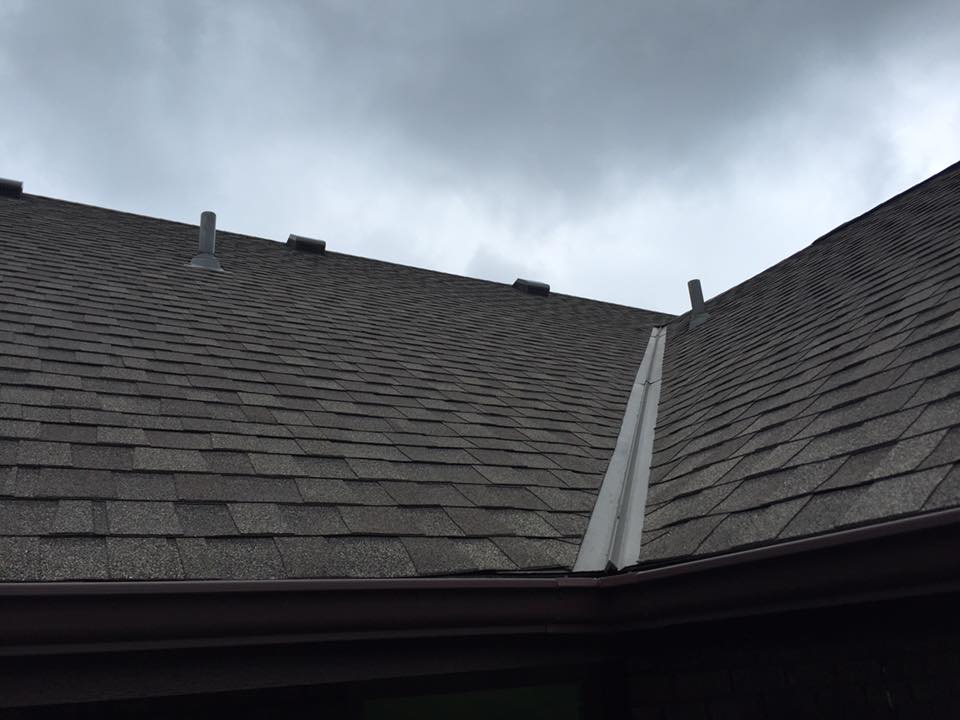 roof shingles close up with grey skies