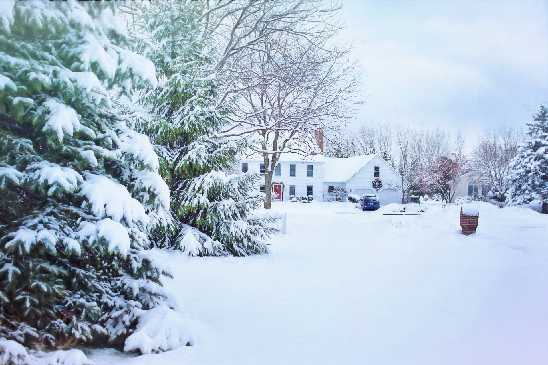 Snow covered neighborhood homes and trees