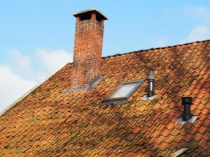 brick chimney on roof requiring maintenance