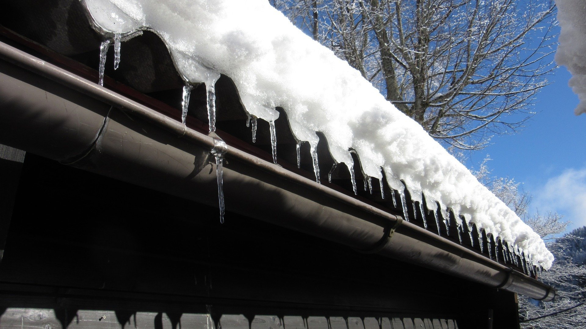 How Do Snow and Ice Damage My Roof?