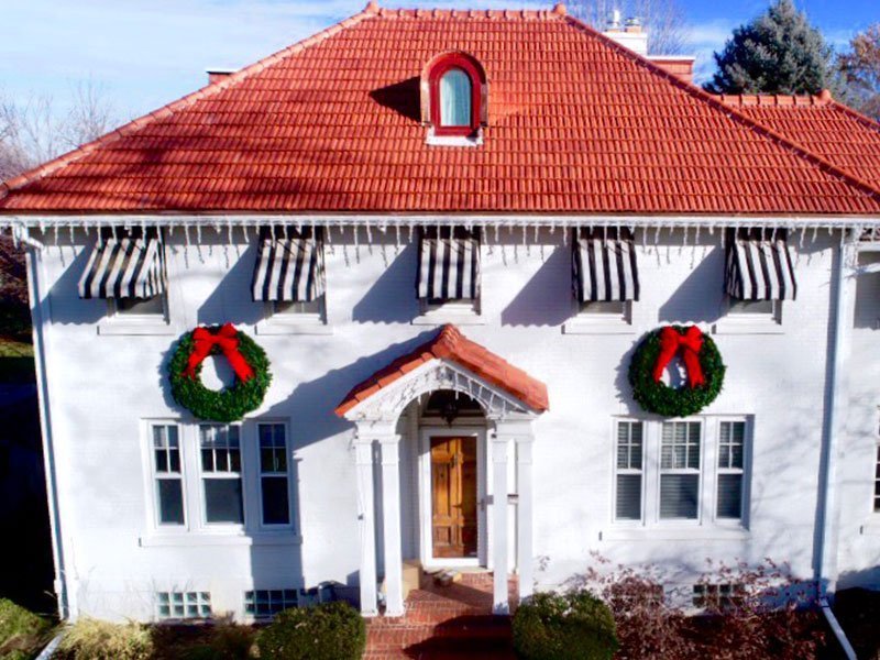 Front of beautiful white home with Ludowici tile roof project completed by Exterior Remodel & Design in Omaha, NE